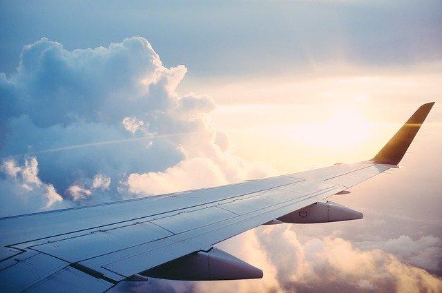 Airplane wing in front of sunset
